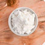 Dry protein powder in a small bowl