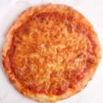 Low calorie pizza crust topped with low fat mozzarella cheese and tomato sauce