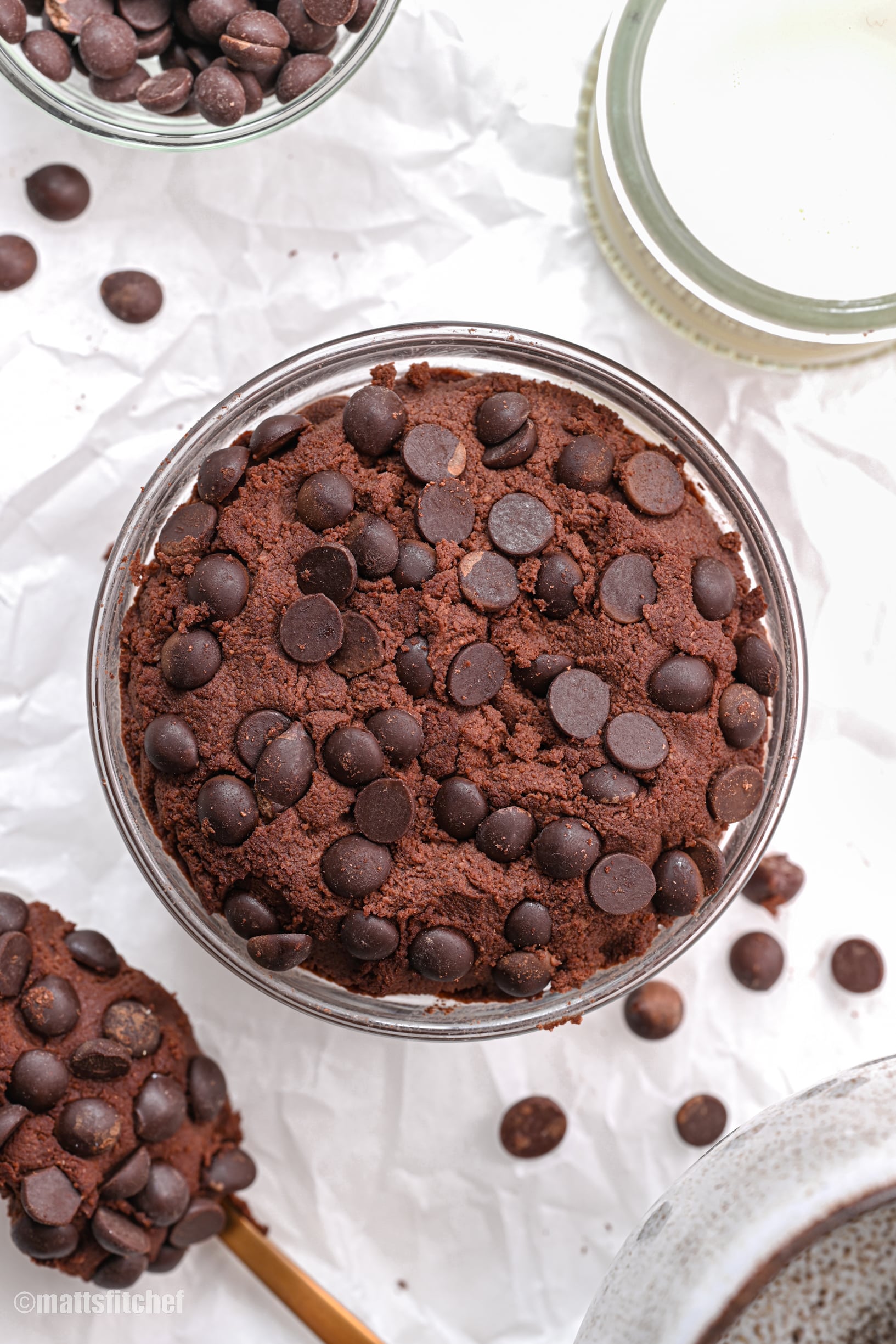 Chocolate truffle beside bulk measuring scoop with cocoa beans on