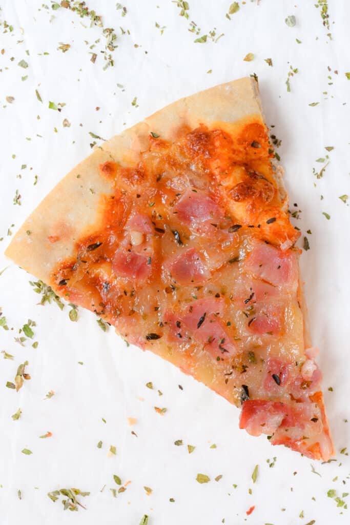 slice of protein pizza without yeast, with ham and low fat cheese as topping