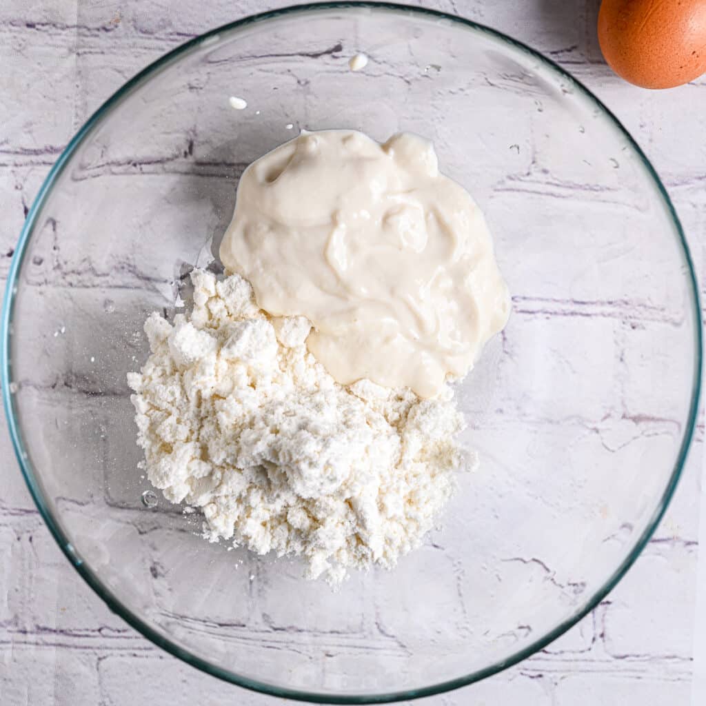 Protein Pancake Ingredients in a Bowl – A glass bowl with protein powder, Greek yogurt.