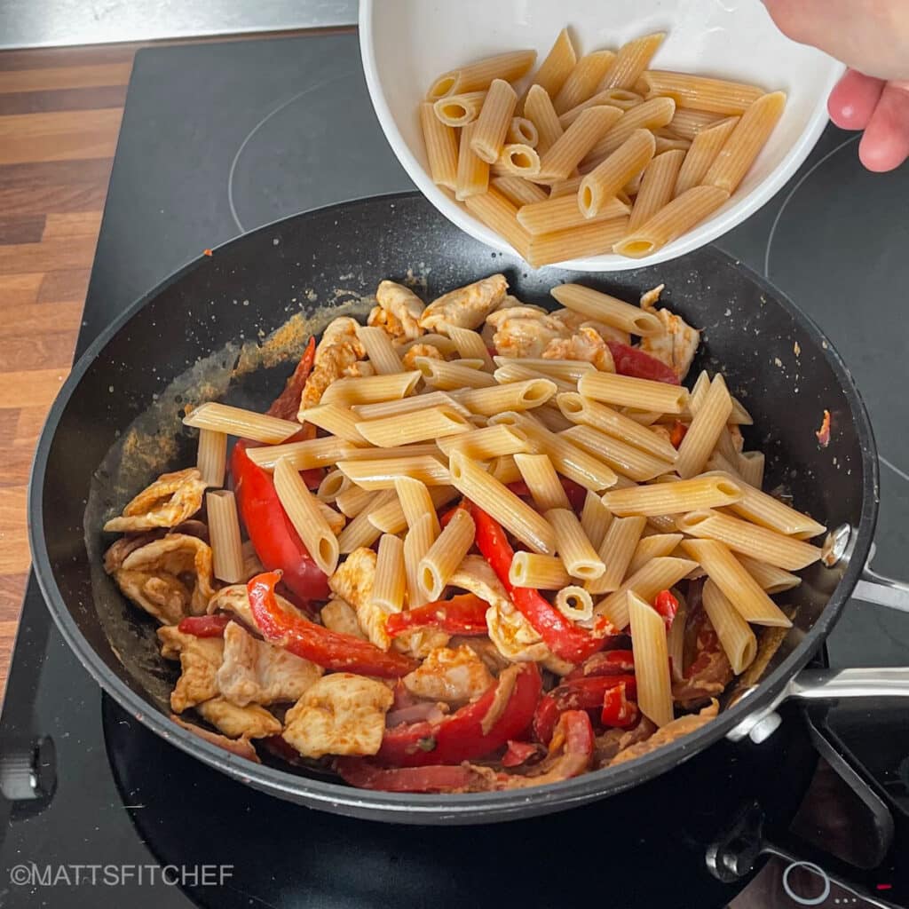 Add pasta to cooked chicken and sautéed vegetables