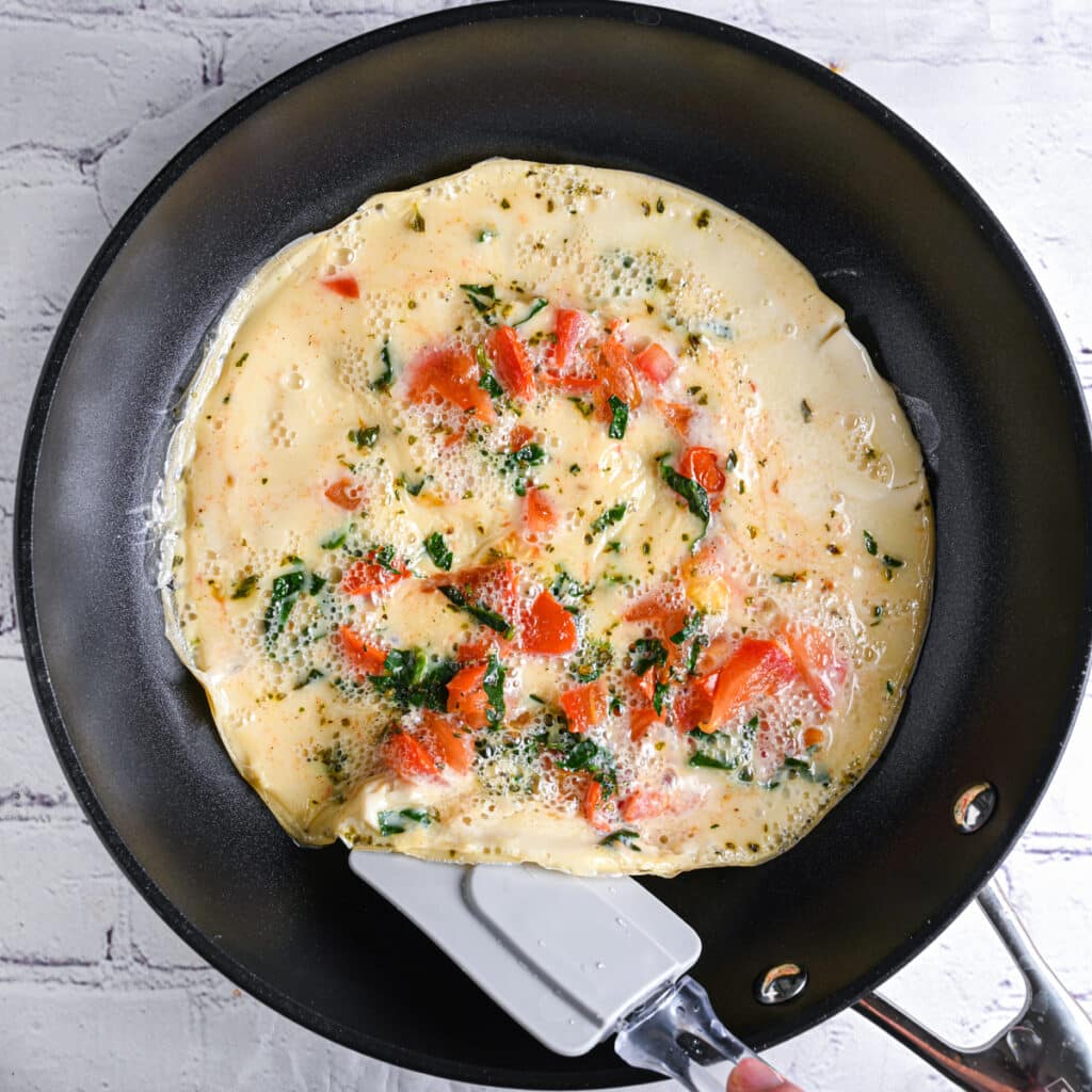 Flipping egg white omelette with spatula