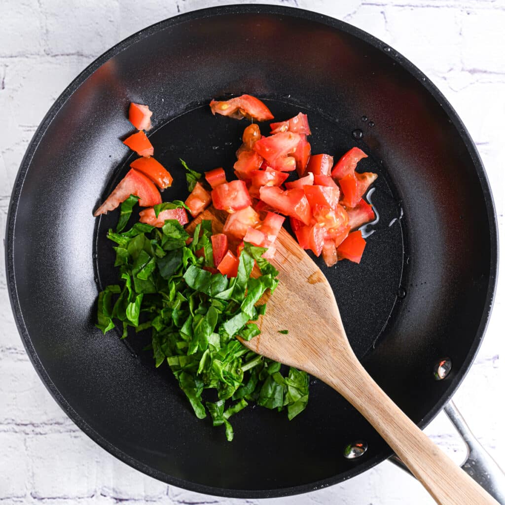 Spinach and tomatoes in skillet