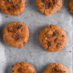 Unbaked protein cookies arranged on parchment paper, ready to go into the oven