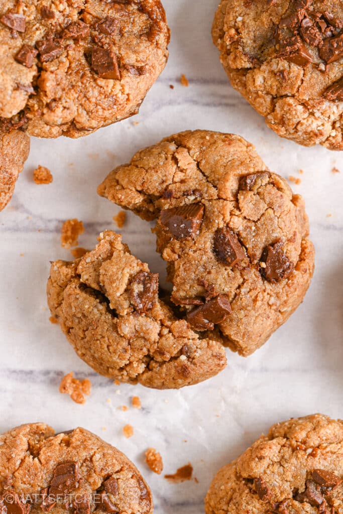 A deliciously soft protein cookie with melted chocolate chips, showing its perfect chewy texture.