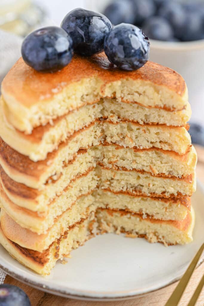 Thick, soft protein pancakes stacked high, perfect for a healthy, macro-friendly breakfast.