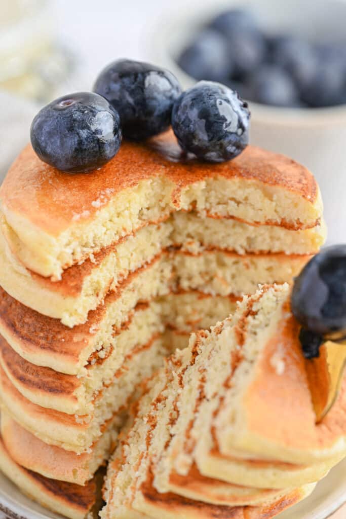 Fluffy protein pancakes made with protein powder, served with fresh blueberries.