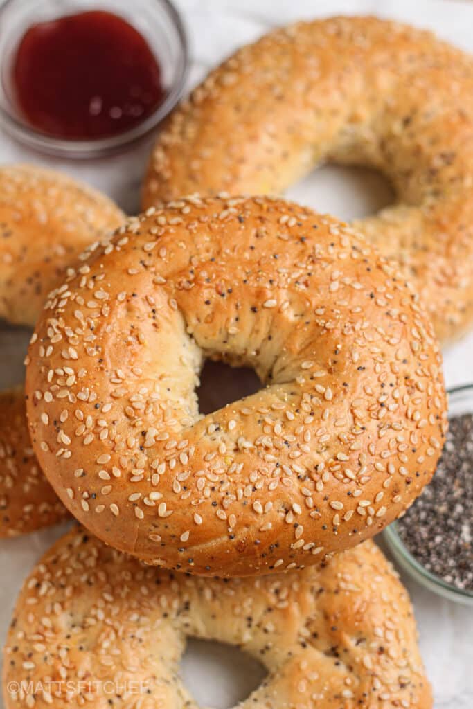 Golden-brown cottage cheese bagels topped with sesame seeds and poppy seeds.