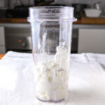 A blender filled with rich, creamy cottage cheese.