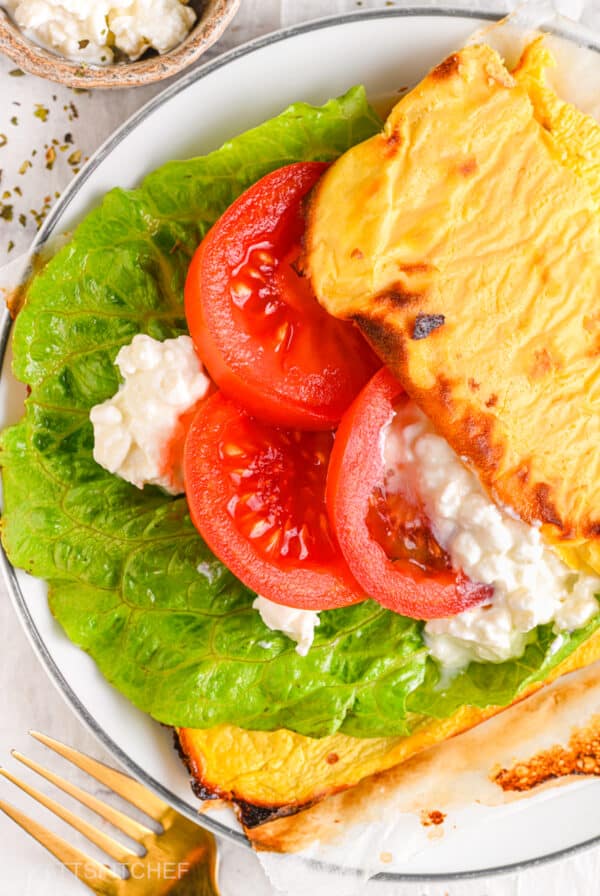 A fresh and healthy open-faced sandwich made with cottage cheese flatbread, crisp lettuce, juicy tomato slices, and extra cottage cheese for a protein-packed meal.