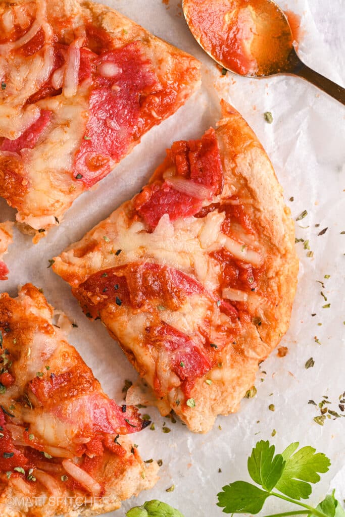 Close-up of pizza slice – A detailed view of a protein-packed pizza slice with golden crust, melted cheese, and savory turkey salami.