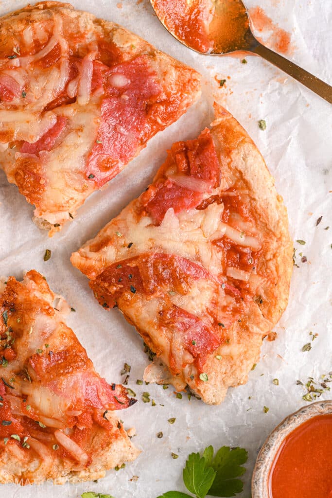 Close-up of pizza slice – A detailed view of a protein-packed pizza slice with golden crust, melted cheese, and savory turkey salami.