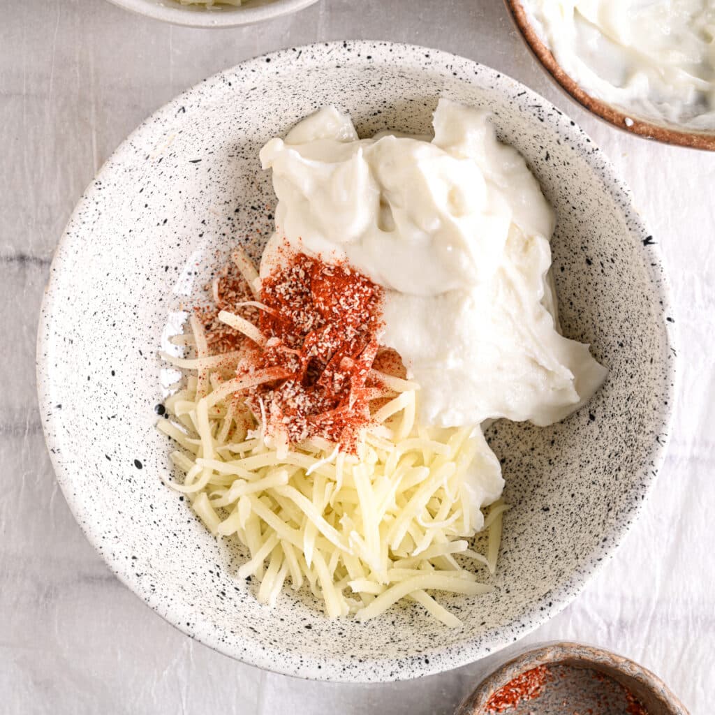 Taco seasoning sprinkled over cheese and cottage cheese – Bold and flavorful taco seasoning added to enhance the queso dip.