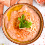 Finished cottage cheese queso with toppings – A smooth, cheesy queso dip garnished with fresh parsley and extra cheese.