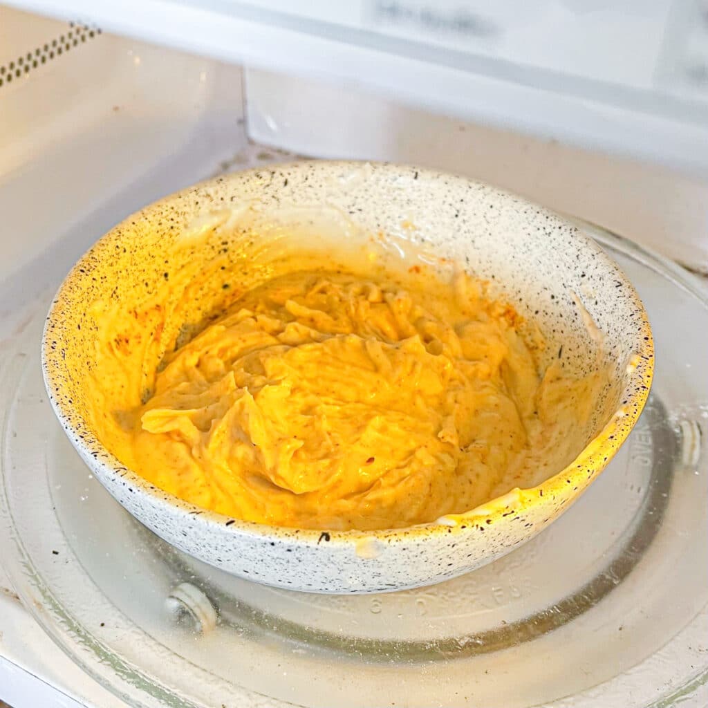 Microwaving blended cottage cheese with shredded cheese and taco seasoning
