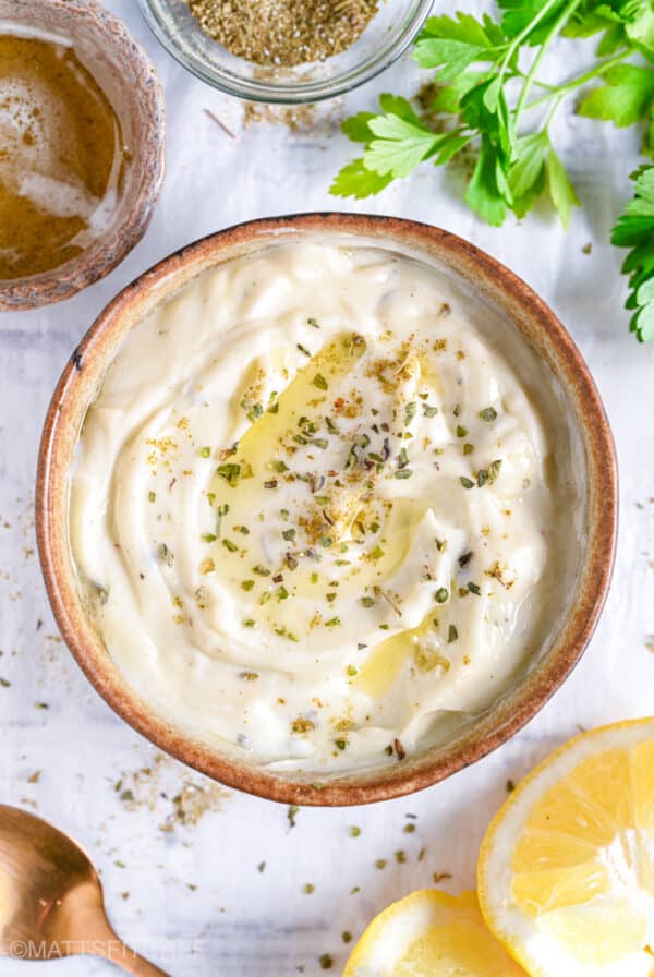 Smooth and creamy Greek yogurt ranch dressing in a rustic bowl, ready to use as a low calorie dip or dressing.