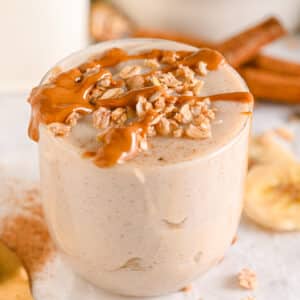 1000 Calorie Smoothies to Gain Weight and Build Muscle &ndash; served in a glass with calorie-dense peanut butter and protein granola on top.