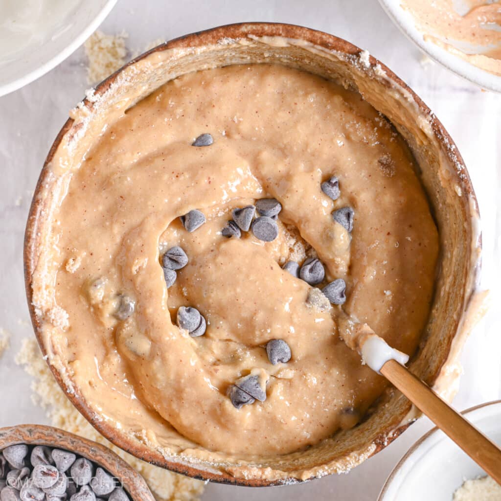 Thick, gooey, and delicious-looking protein cookie dough with chocolate chips, ready to eat.