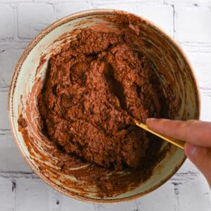 Mixing sweet potato brownie batter until smooth.