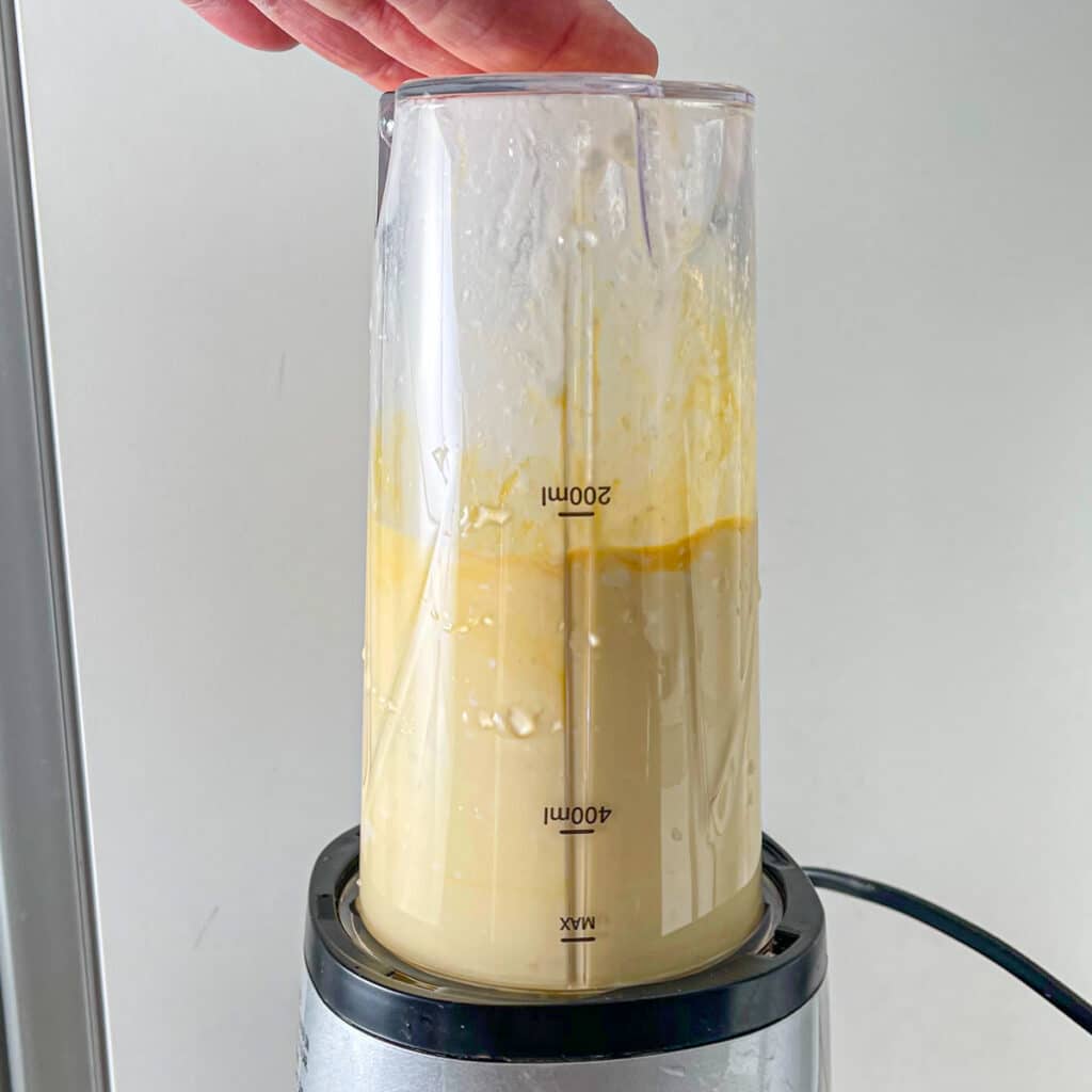 Blending cottage cheese with eggs in a bullet blender.