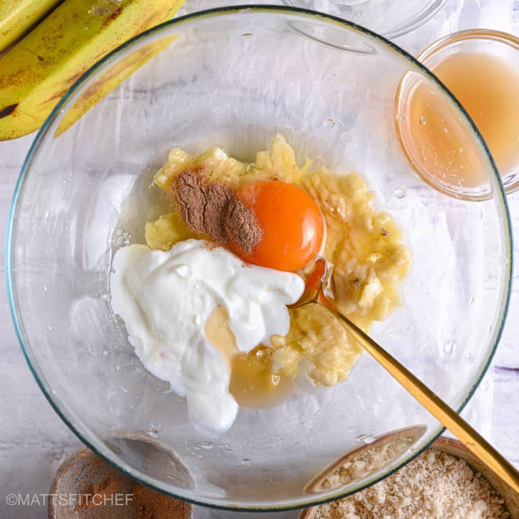 Mashed bananas with egg, maple syrup, Greek yogurt, vanilla extract and ground cinnamon before mixing until smooth.