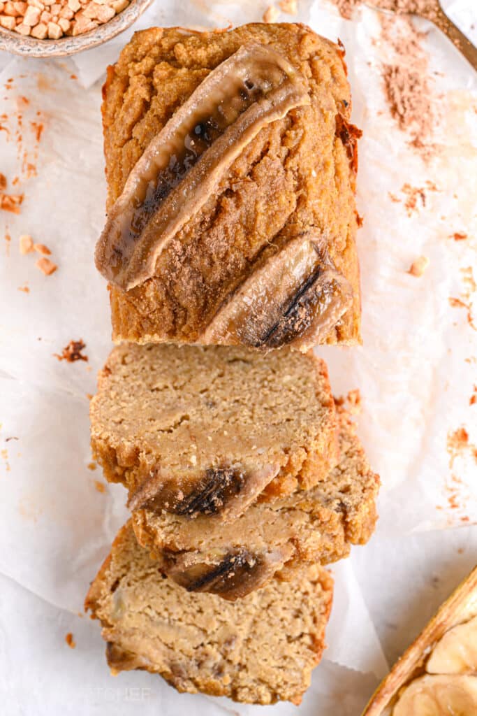 Healthy almond flour banana bread shown from top, sliced into soft, moist slices ready to be served with toppings.