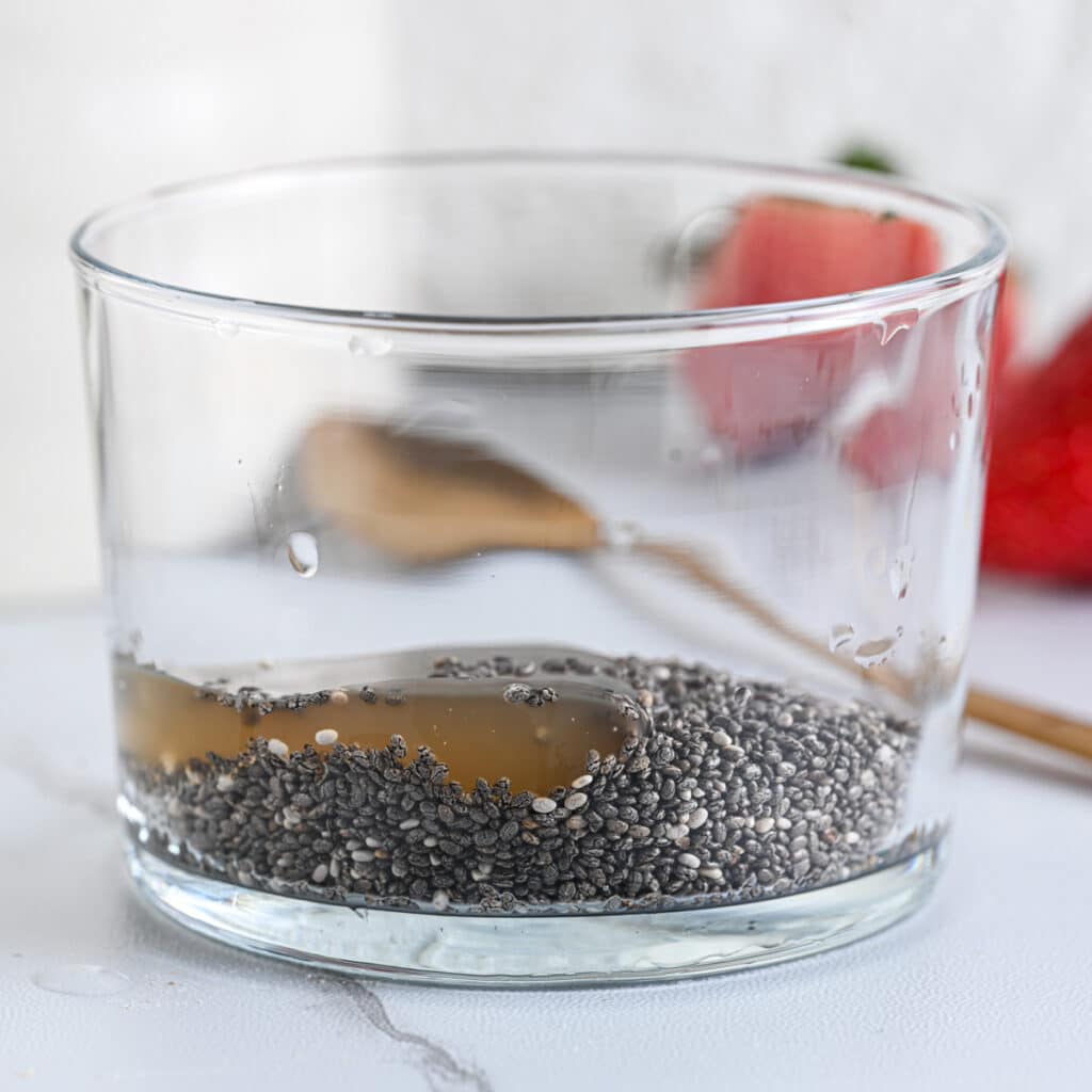 Maple syrup added to chia seeds, optional for a sweeter pudding