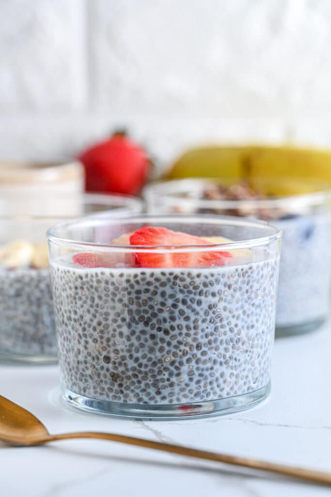 Creamy chia seed pudding in a glass topped with fresh strawberry slices, perfect for a healthy breakfast or snack