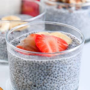 Close-up of chia pudding with almond milk, topped with sliced strawberries and bananas, low carb and dairy-free option