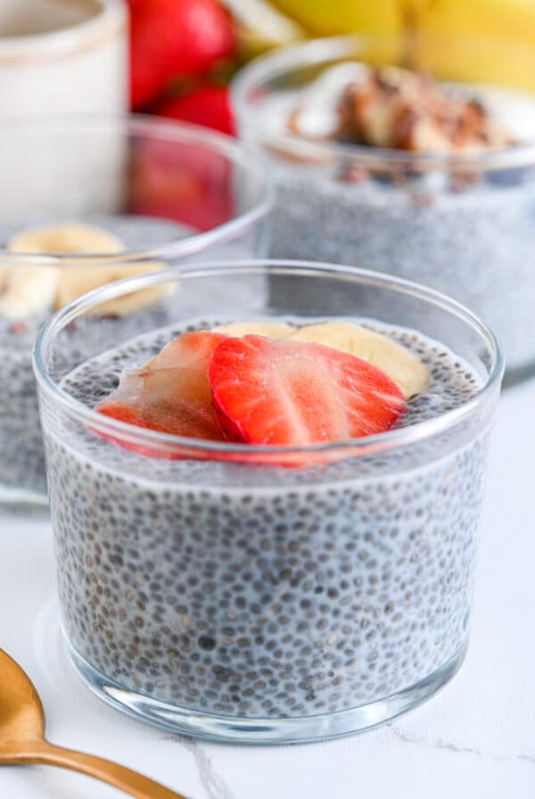 Close-up of chia pudding with almond milk, topped with sliced strawberries and bananas, low carb and dairy-free option