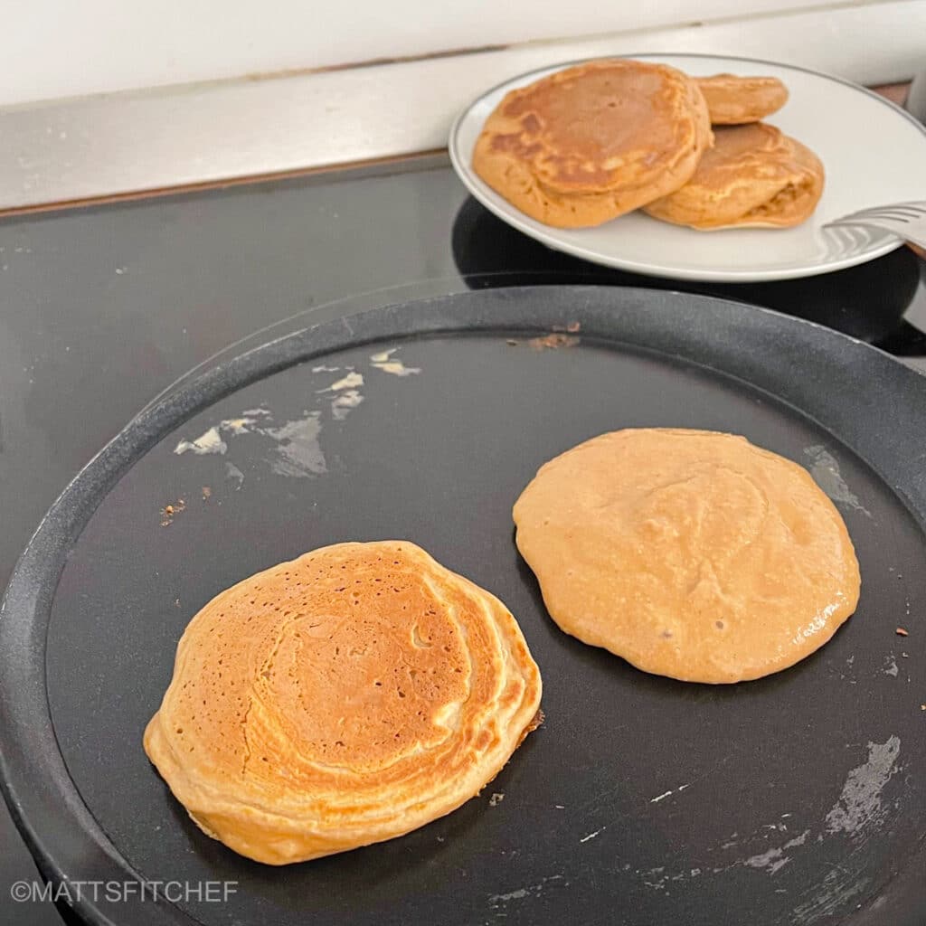 Cooking pancakes in a large nonstick skillet until soft and fluffy.
