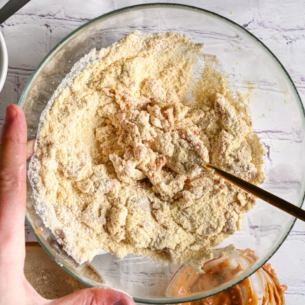 Mixing protein dough with a golden fork until smooth and workable.