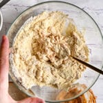 Mixing protein dough with a golden fork until smooth and workable.