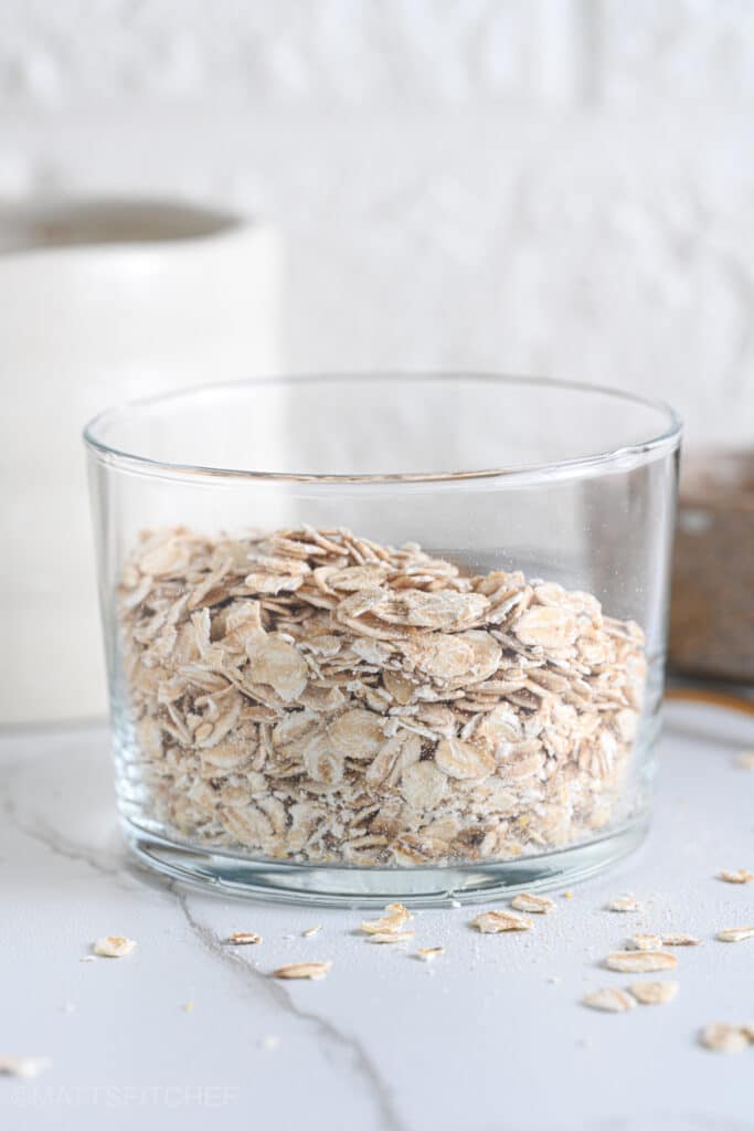 Old fashioned rolled oats in a glass to make overnight oats