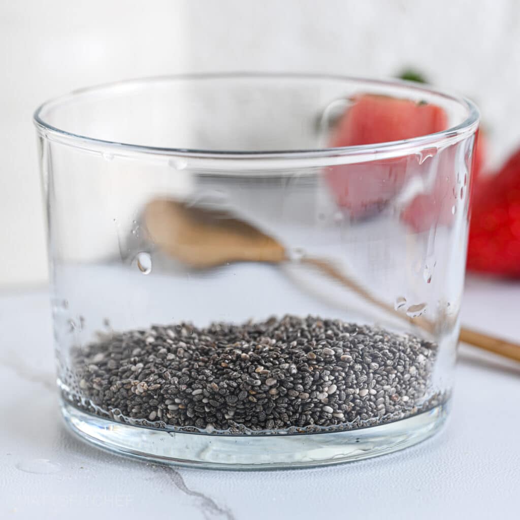 Chia seeds in a glass cup as first ingredients for the protein pudding
