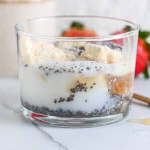 Milk added to chia seeds and protein powder, before stirring in a creamy protein pudding.