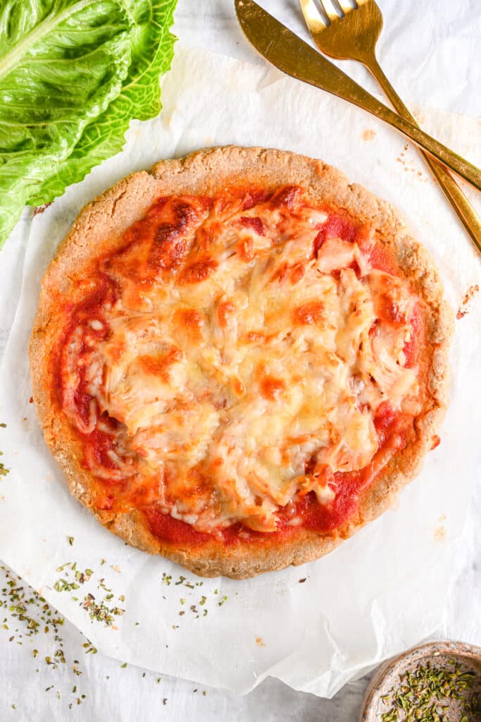 High protein pizza baked until melting cheesy and golden brown, ready to be sliced and served.