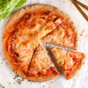 High protein pizza crust with shredded chicken cut into 3 slices.