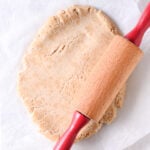 Rolling Greek yogurt protein dough into a circle with a rolling pin.