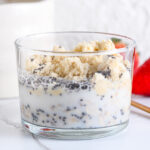 Milk being added to protein powder and rolled oats, ready to be stirred until creamy