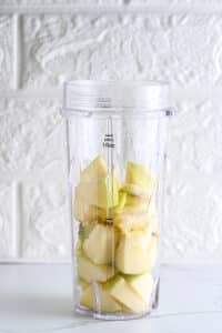 Chunks of sweet apple added to a blender, ready to make pudding