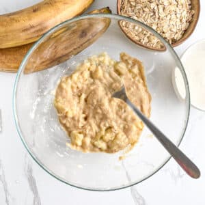Mashed ripe bananas stirred with creamy peanut butter, ready to add oats for bars