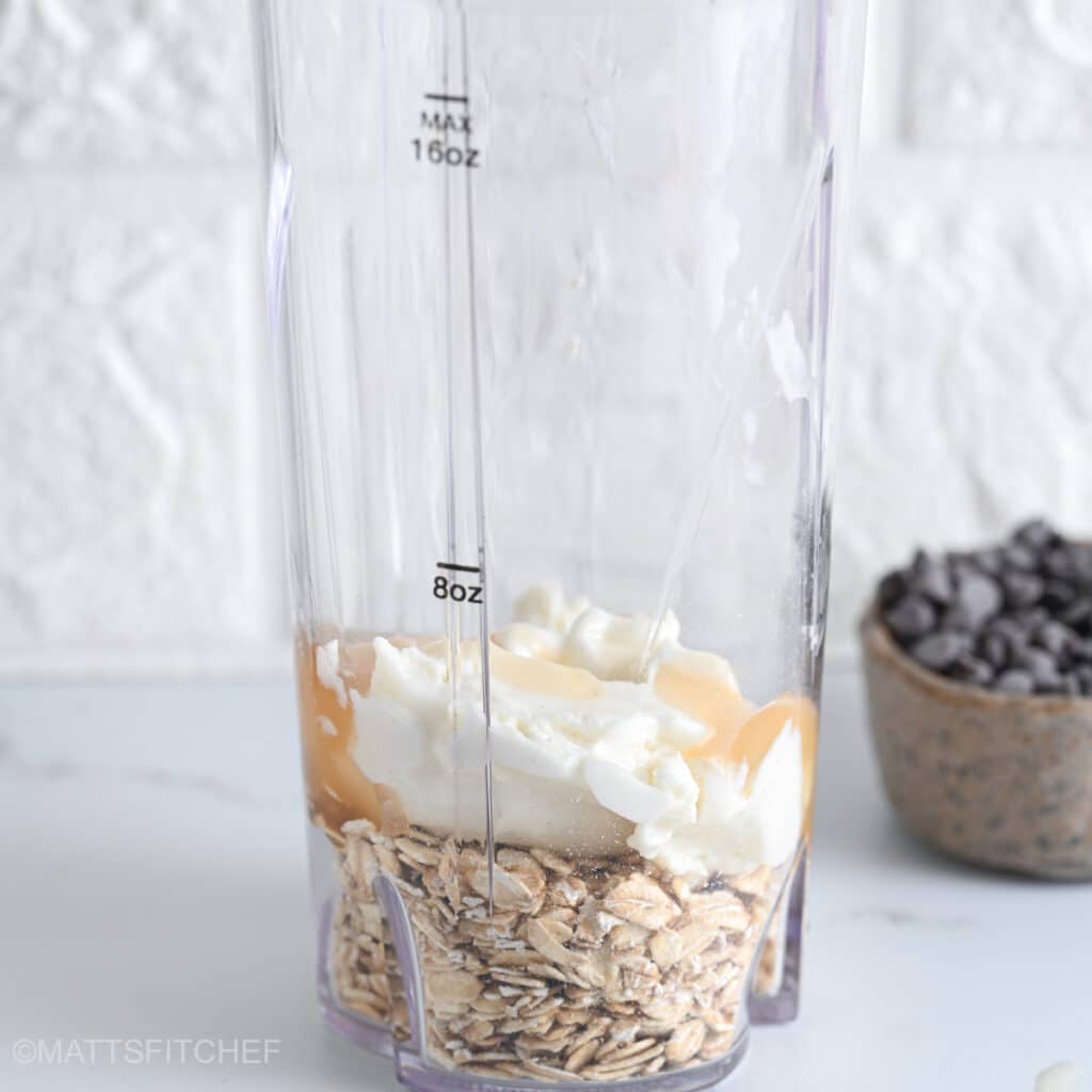 Rolled oats with Greek yogurt and maple syrup in a blender