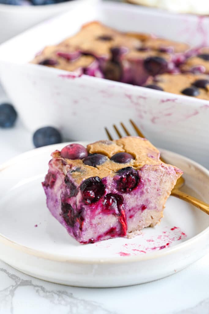 Slice of blueberry cottage cheese breakfast bake with juicy berries