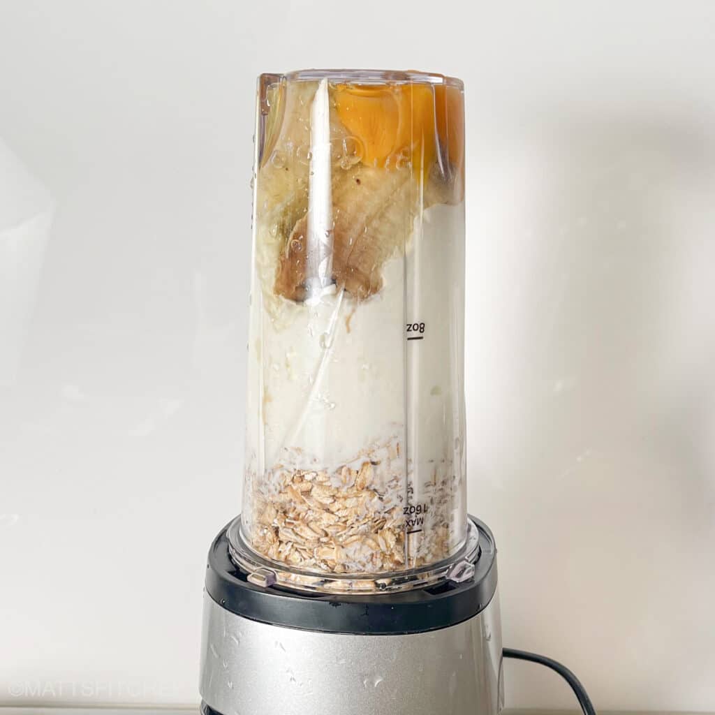 Blender filled with ingredients, ready to blend until smooth