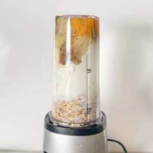 Blender filled with ingredients, ready to blend until smooth