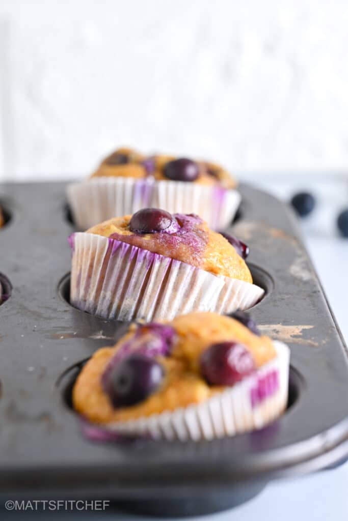 Cottage Cheese Blueberry Muffins in Muffin Tins, shown from the front.