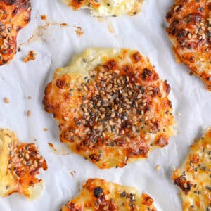 Crispy cottage cheese chips baked in oven, topped with sesame seeds.