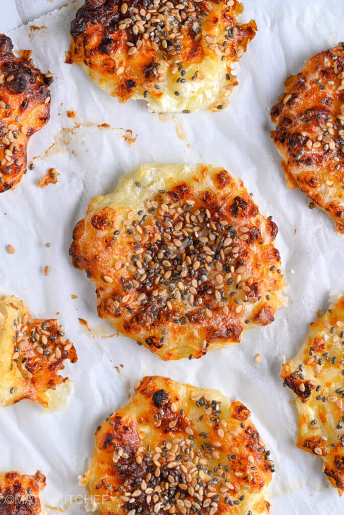 Crispy cottage cheese chips baked in oven, topped with sesame seeds.